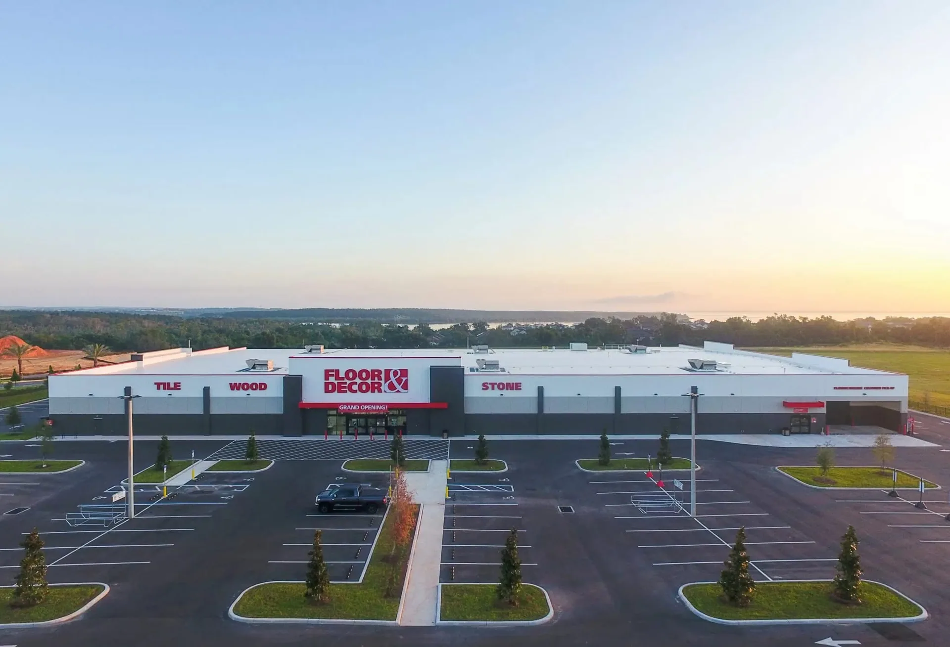 Aerial view of the store and parking lot at sunset.