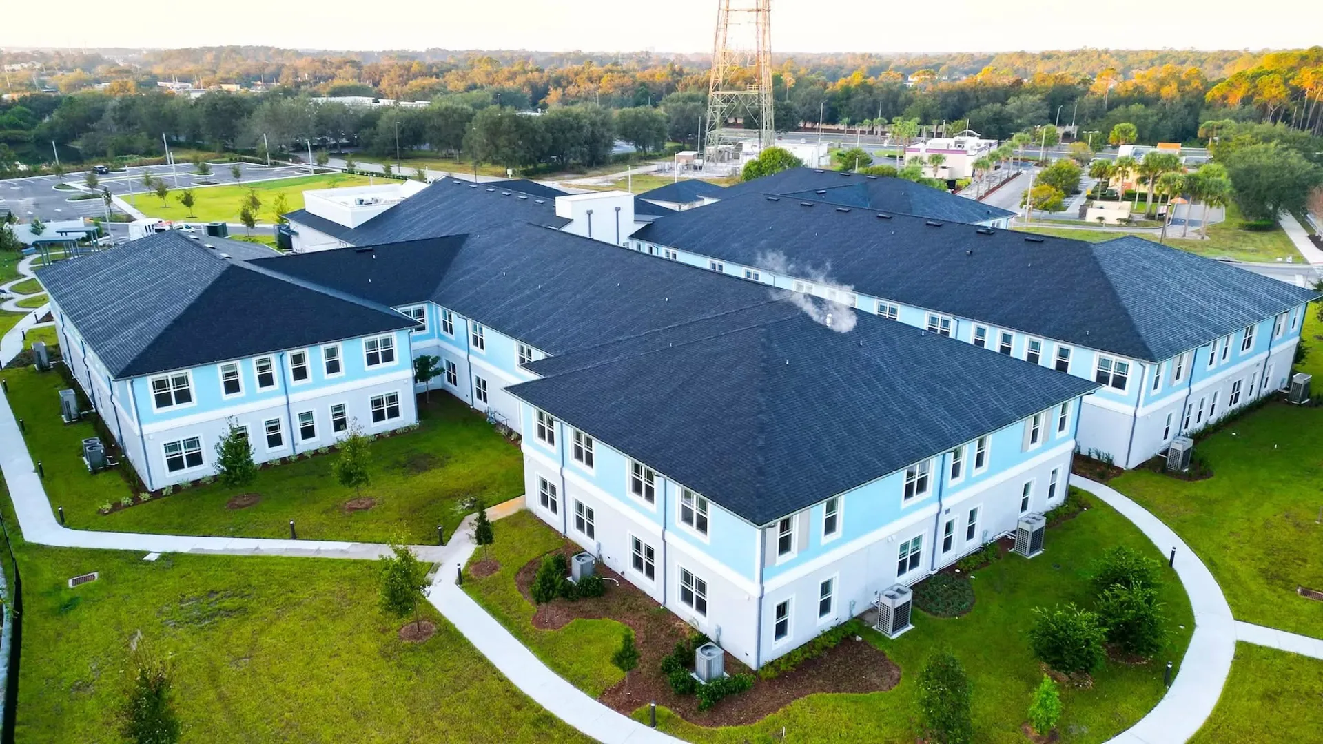 Aerial view of the two-story buildings and landscaped grounds.